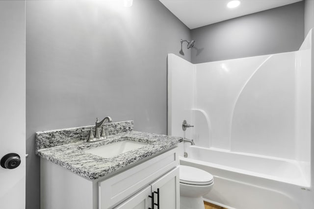 full bathroom featuring vanity, bathing tub / shower combination, and toilet