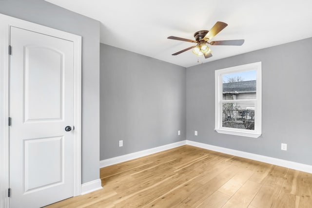 empty room featuring ceiling fan and light hardwood / wood-style flooring