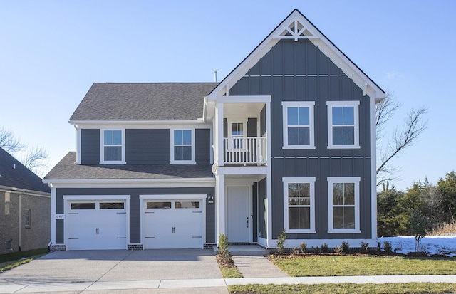 view of front of house with a balcony, a garage, and a front yard