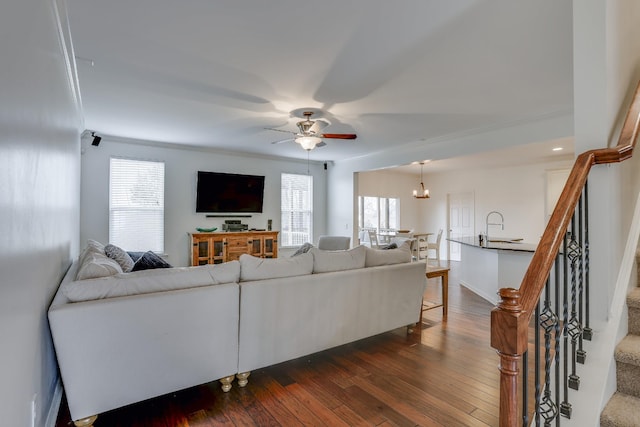 living room featuring plenty of natural light, dark hardwood / wood-style floors, sink, and ceiling fan