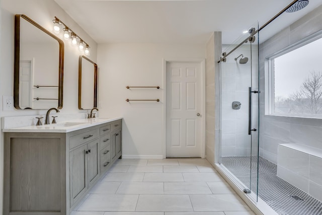 bathroom featuring a shower with door, vanity, and tile patterned flooring