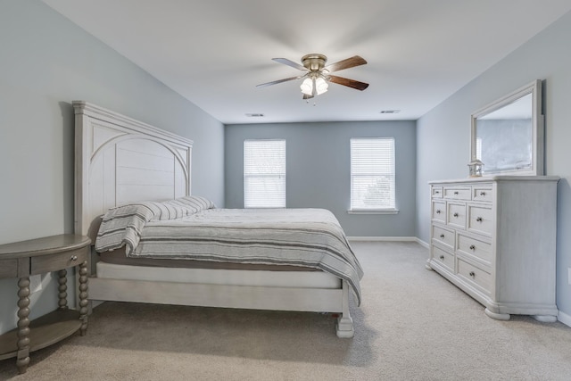 bedroom featuring ceiling fan and light carpet