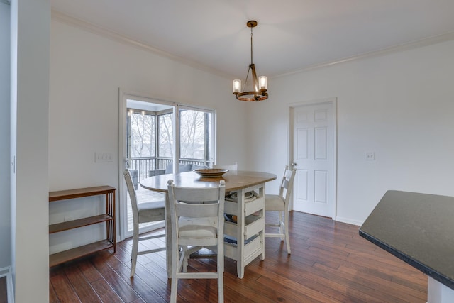 dining space with an inviting chandelier, dark wood-type flooring, and ornamental molding