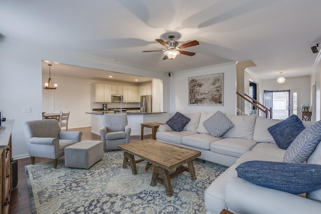 living room featuring hardwood / wood-style floors and ceiling fan with notable chandelier