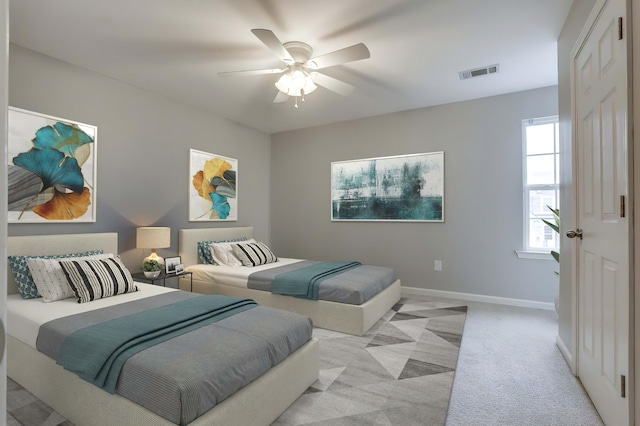 bedroom with light colored carpet and ceiling fan