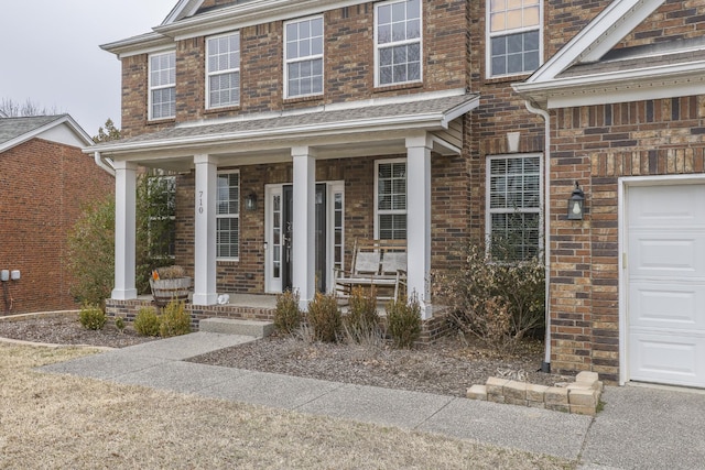 view of front facade featuring a porch and a garage