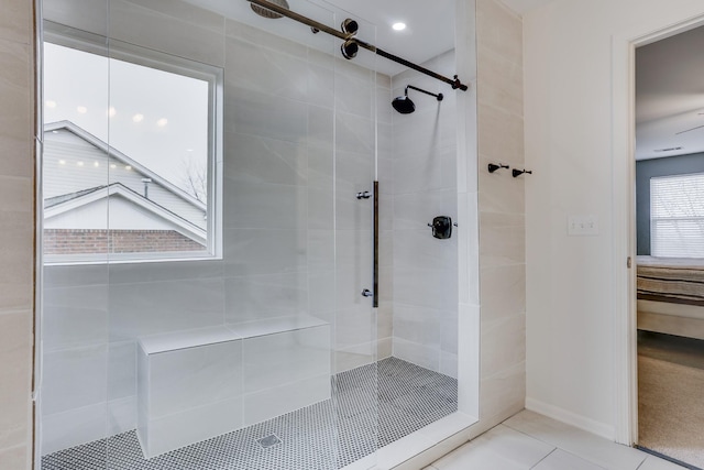 bathroom with an enclosed shower and tile patterned flooring