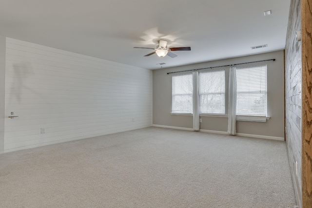 spare room with light carpet and ceiling fan