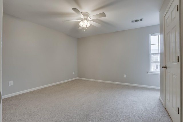 carpeted spare room with a healthy amount of sunlight and ceiling fan