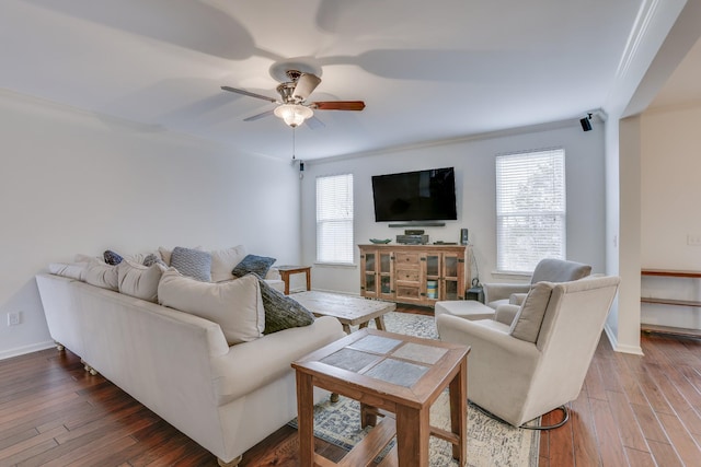 living room with wood-type flooring, ornamental molding, ceiling fan, and plenty of natural light