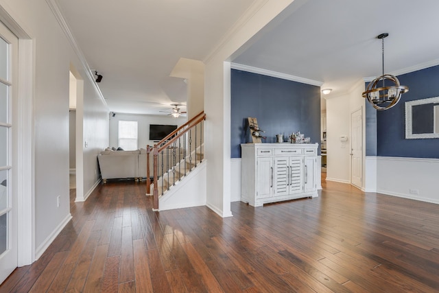 interior space with crown molding, dark hardwood / wood-style floors, and ceiling fan with notable chandelier