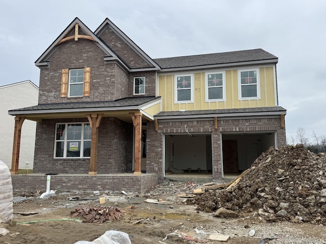 view of front of house with a garage and a porch