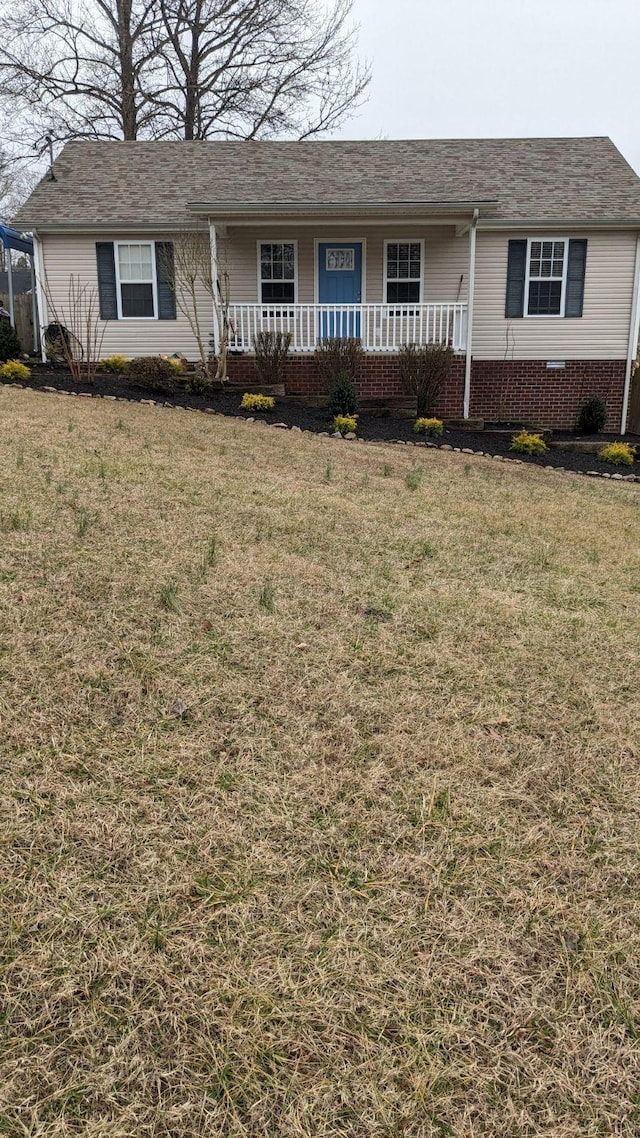 single story home featuring a front lawn and covered porch