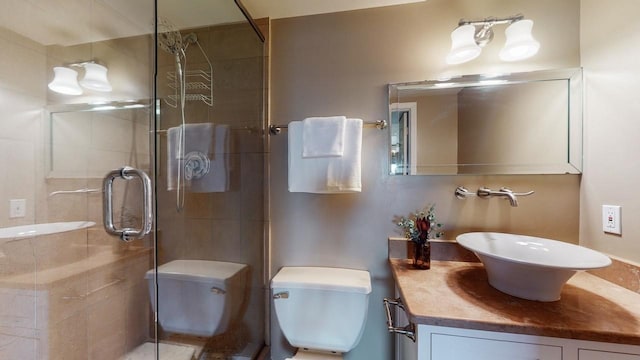 bathroom featuring vanity, an enclosed shower, and toilet