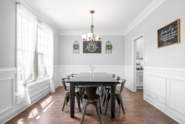 dining space featuring dark hardwood / wood-style flooring, a notable chandelier, and crown molding