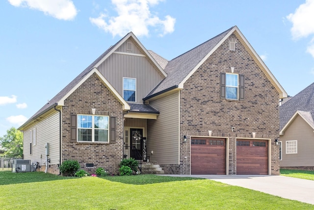 view of front of property featuring a garage, cooling unit, and a front lawn