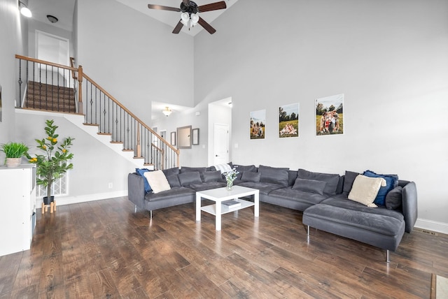 living room featuring dark hardwood / wood-style floors and ceiling fan