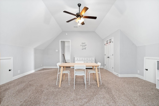 unfurnished dining area with ceiling fan, lofted ceiling, and carpet