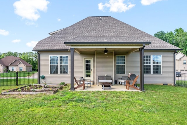 back of house featuring a fire pit, a lawn, ceiling fan, and a patio area