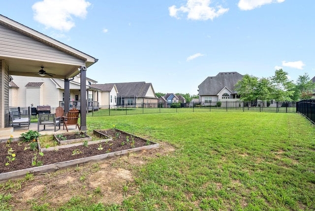 view of yard with ceiling fan and a patio area