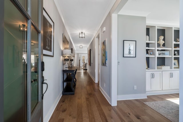 hall with crown molding and dark hardwood / wood-style flooring