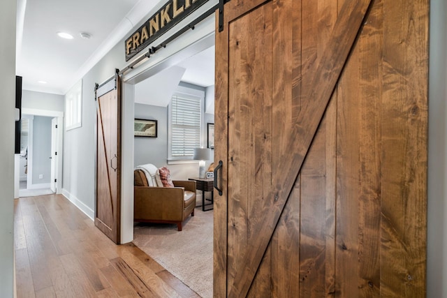 hall featuring light hardwood / wood-style flooring and a barn door