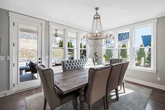 dining room featuring dark wood-type flooring and an inviting chandelier