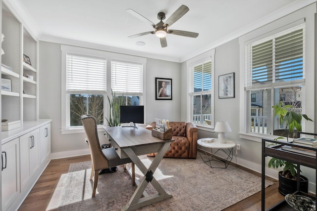 office area with dark hardwood / wood-style flooring, ornamental molding, and ceiling fan