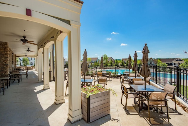 view of patio / terrace featuring ceiling fan and a community pool