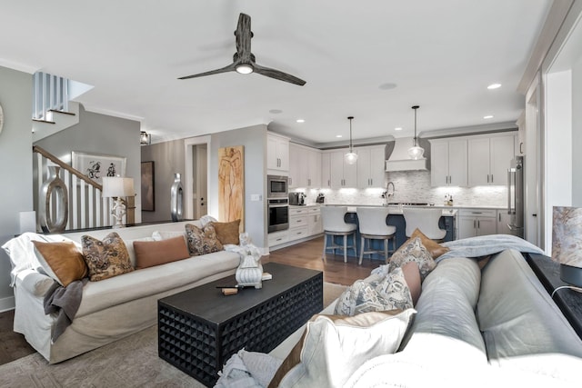 living room with dark wood-type flooring and ceiling fan