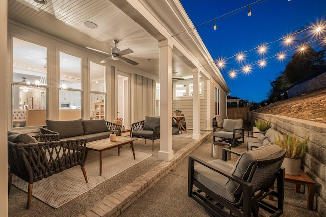 patio at twilight featuring ceiling fan and outdoor lounge area