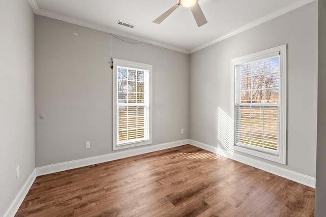 empty room featuring crown molding, ceiling fan, and wood-type flooring