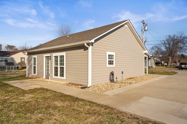 view of home's exterior with a yard and a patio area