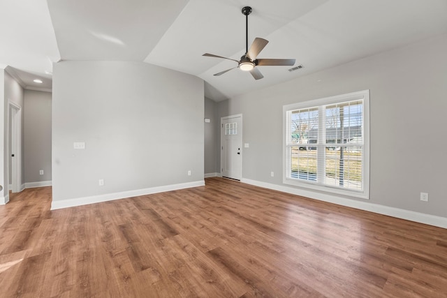 spare room featuring ceiling fan, vaulted ceiling, and wood-type flooring