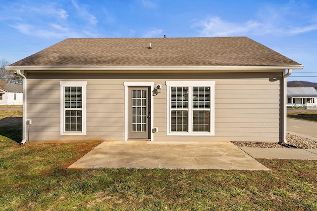 back of house with a yard and a patio