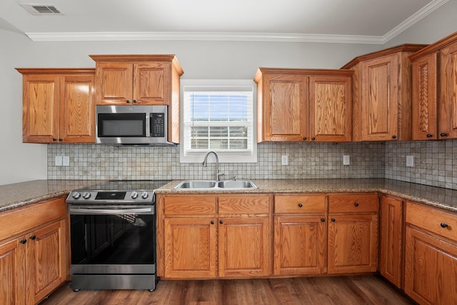 kitchen featuring sink, crown molding, appliances with stainless steel finishes, backsplash, and dark hardwood / wood-style flooring