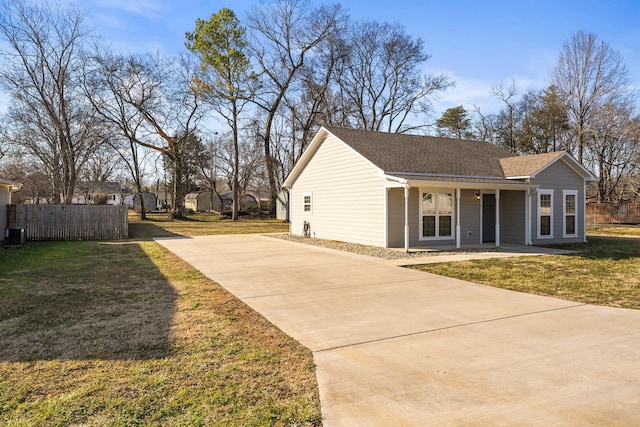 view of side of home featuring a porch and a yard