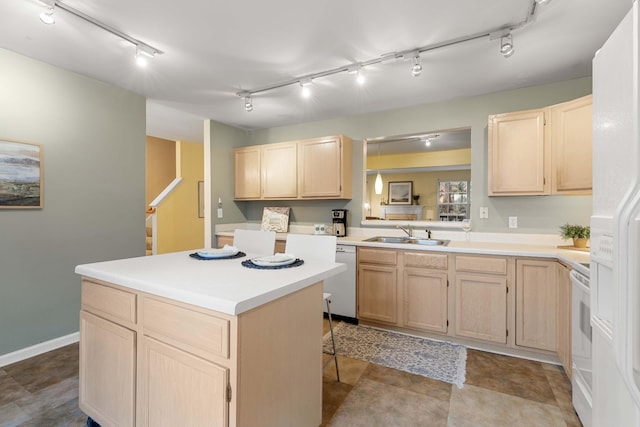 kitchen with light brown cabinetry, sink, a breakfast bar area, a center island, and white appliances