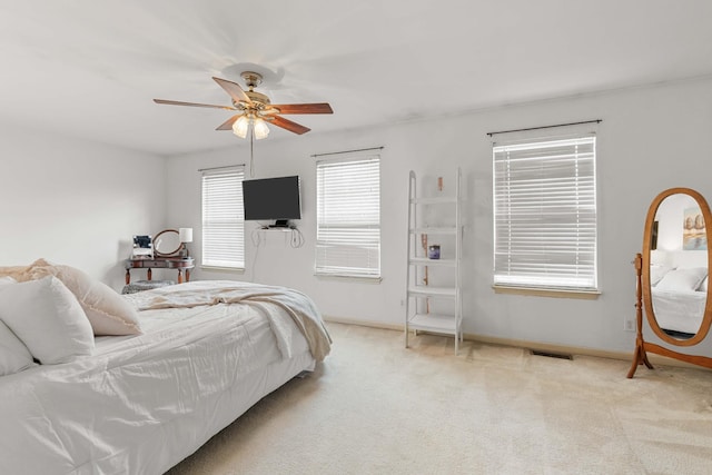 bedroom featuring light colored carpet and ceiling fan