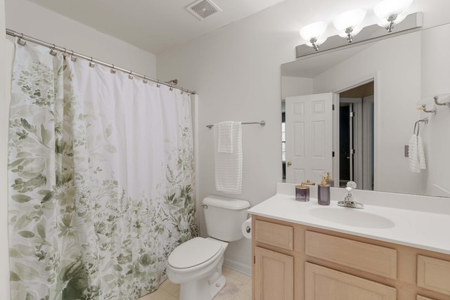 bathroom with vanity, tile patterned floors, and toilet