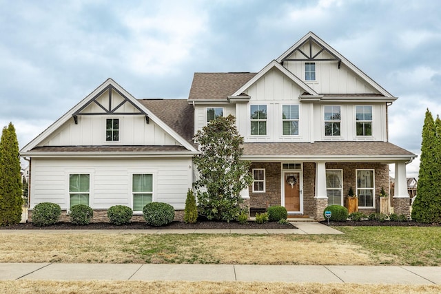 craftsman-style home with a front lawn and covered porch