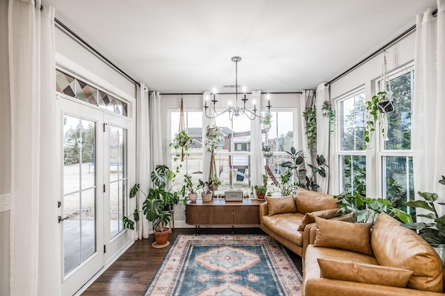 sunroom / solarium with an inviting chandelier