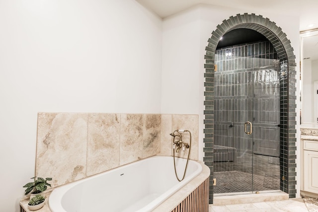 bathroom featuring vanity and shower with separate bathtub