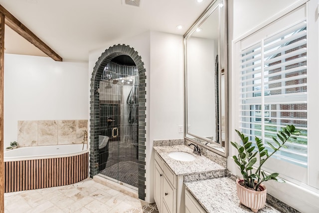 bathroom featuring beamed ceiling, vanity, and separate shower and tub