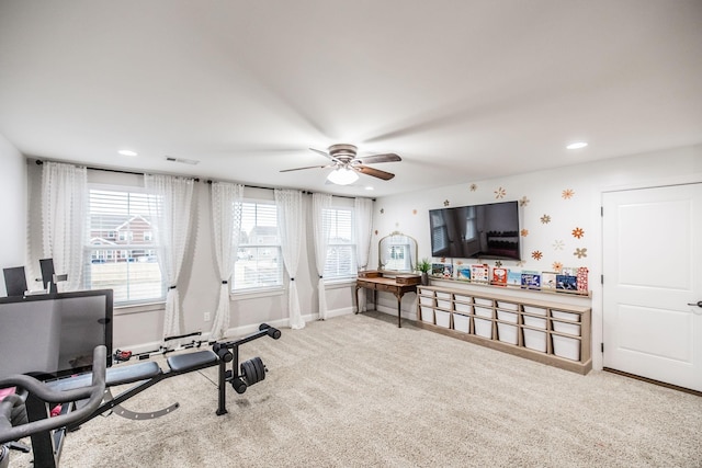 exercise area featuring ceiling fan and carpet flooring