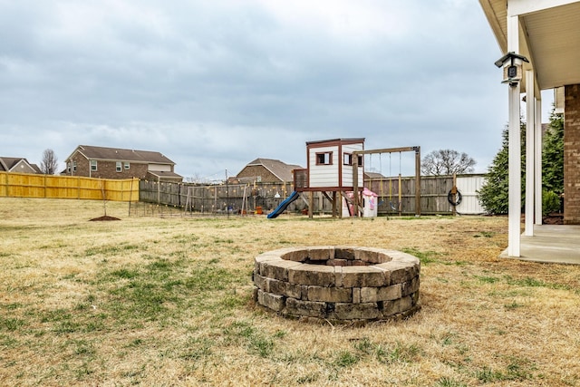 view of yard with a playground and an outdoor fire pit