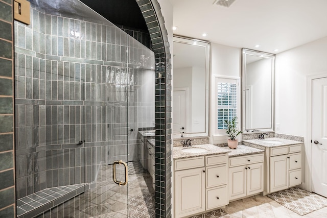 bathroom featuring vanity and a shower with shower door