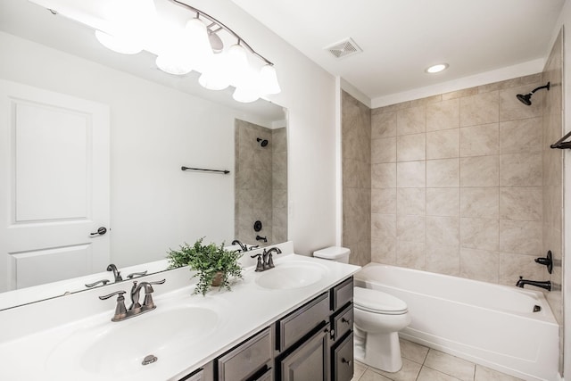 full bathroom featuring vanity, tiled shower / bath, tile patterned floors, and toilet