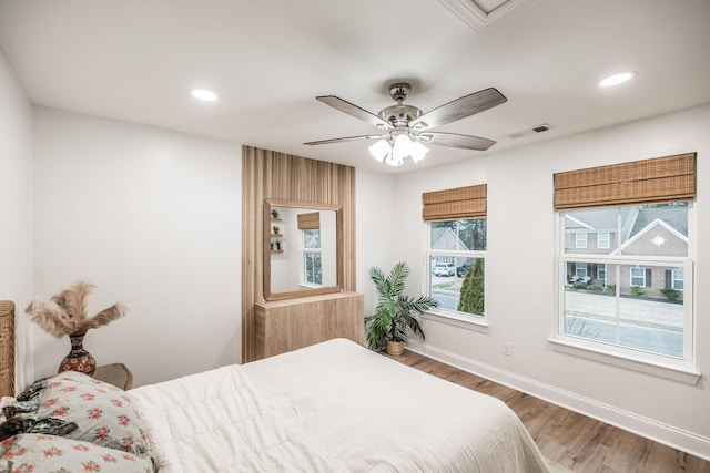 bedroom with hardwood / wood-style floors and ceiling fan