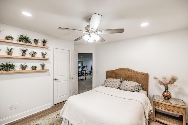 bedroom featuring ceiling fan and dark hardwood / wood-style flooring